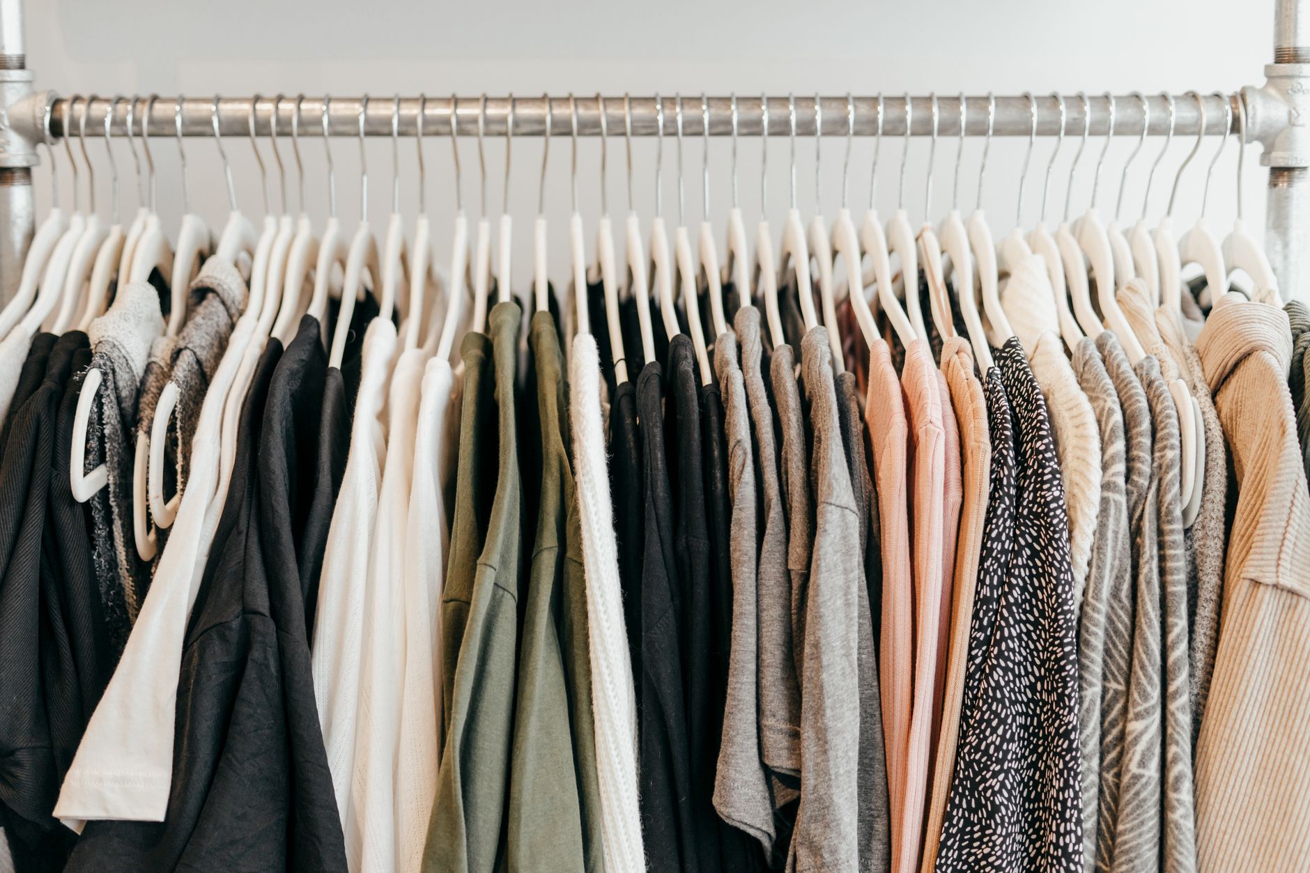 Neatly arranged clothing on hangers showcasing a variety of fabrics and styles.