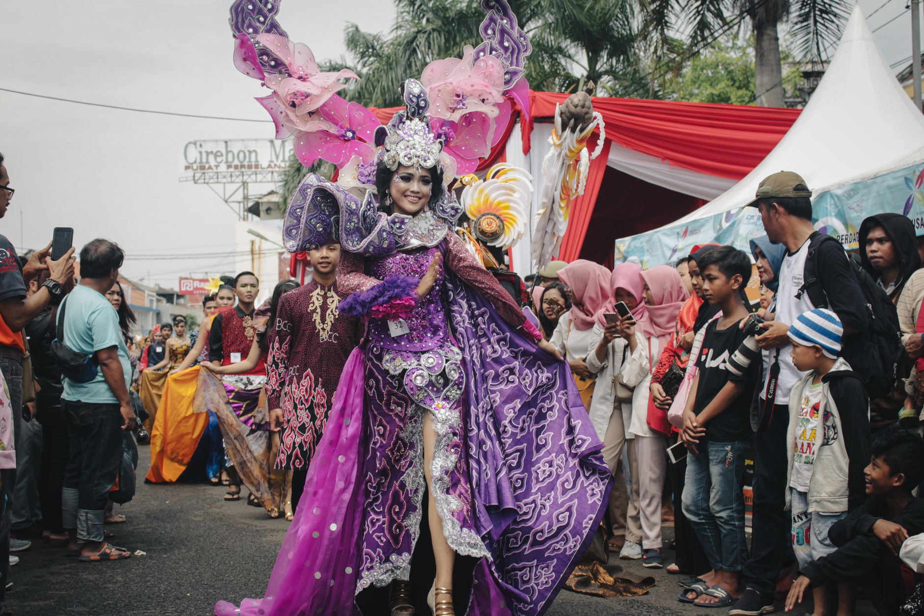 Vibrant street festival in West Java, showcasing traditional Indonesian costumes and cultural diversity.